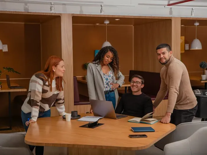 Group of professionals collaborating around a table in a bright modern office